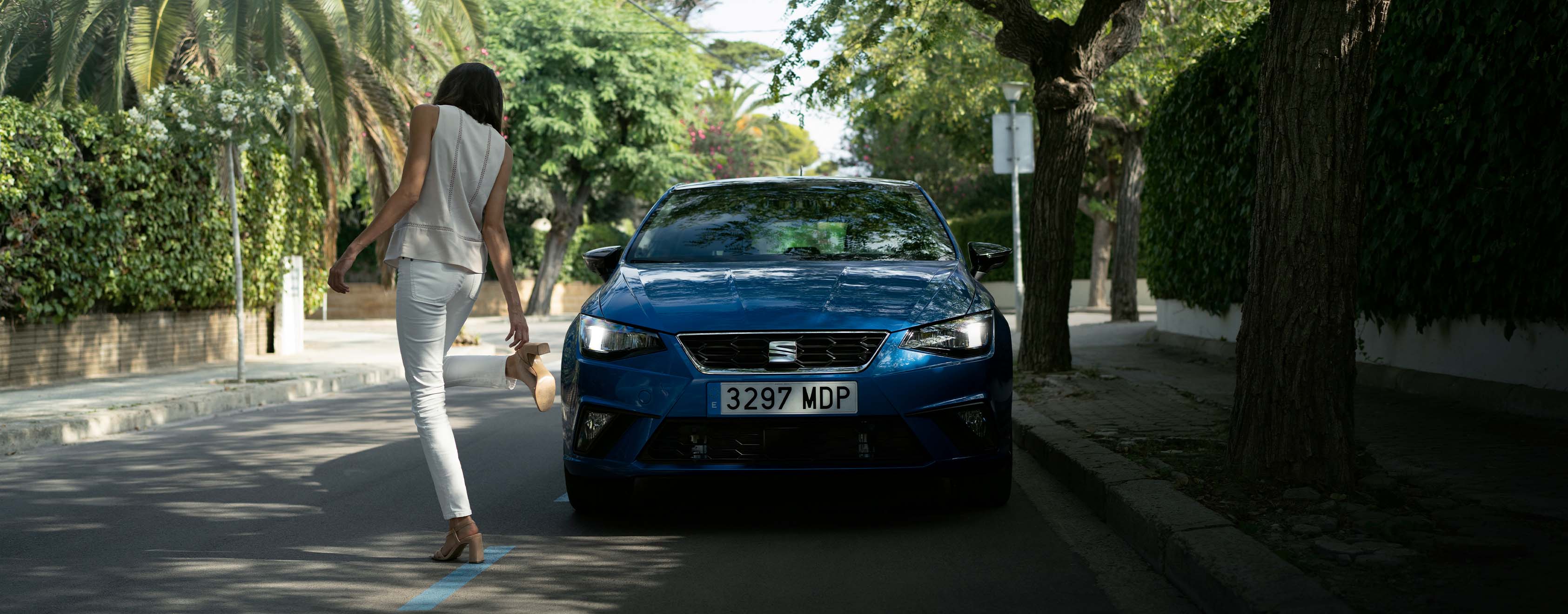 SEAT new car services maintenance independent garages – Red SEAT Ibiza city car hatchback parked in front of a red garage wall